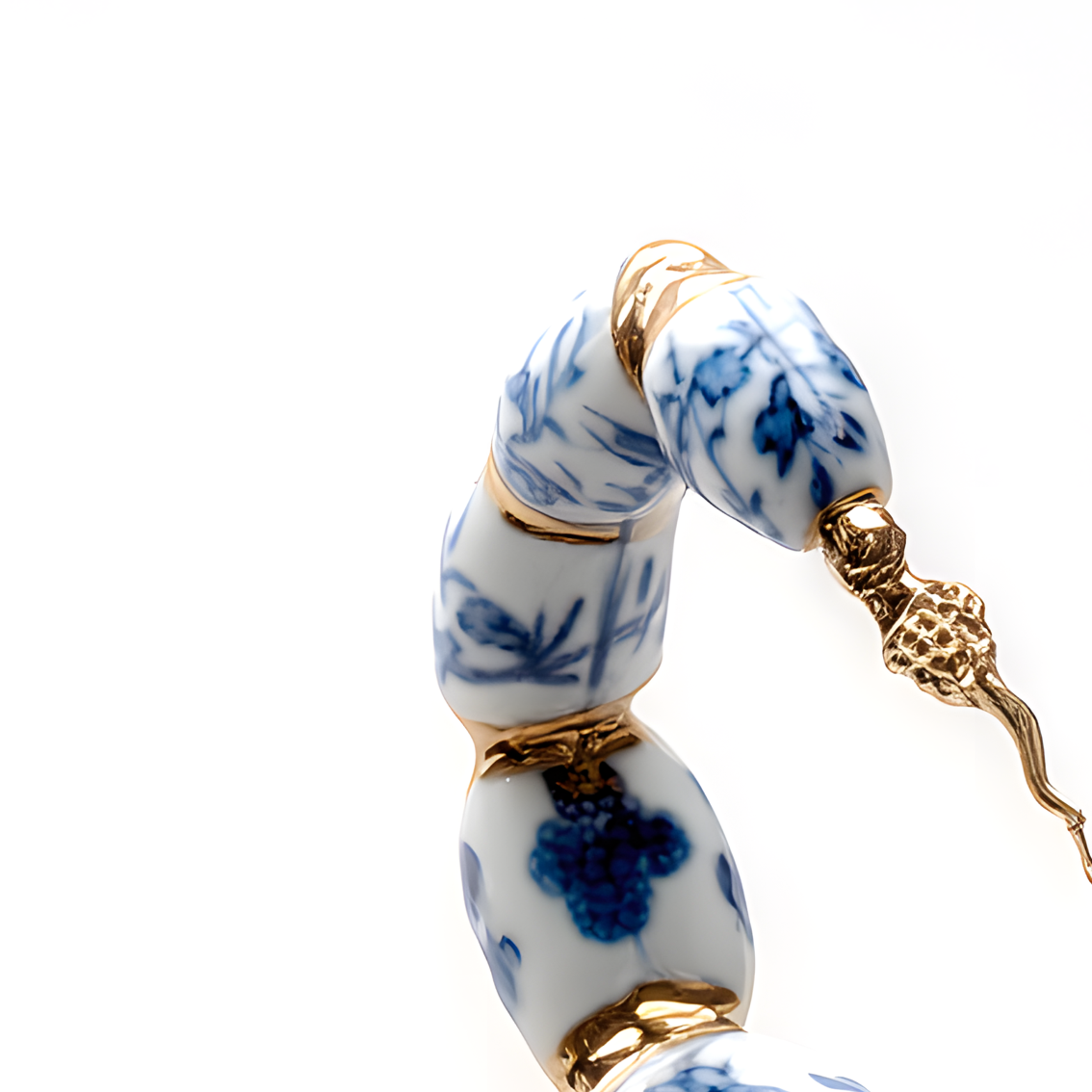 Detail of the gold-gilt tail and stinger with cobalt floral motifs